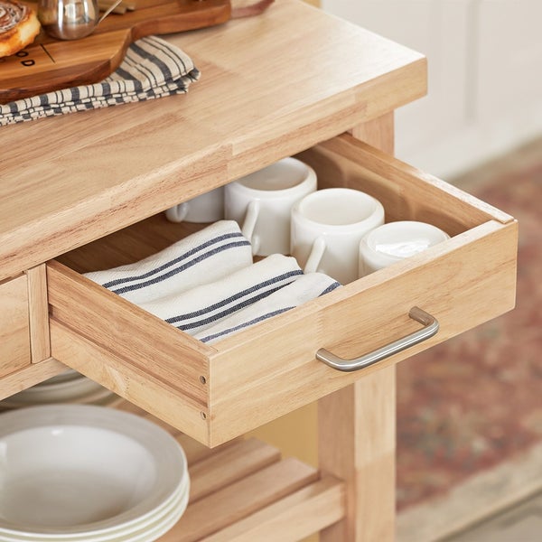 Küchenwagen mit offener Schublade gefüllt mit Geschirrtüchern und Tassen