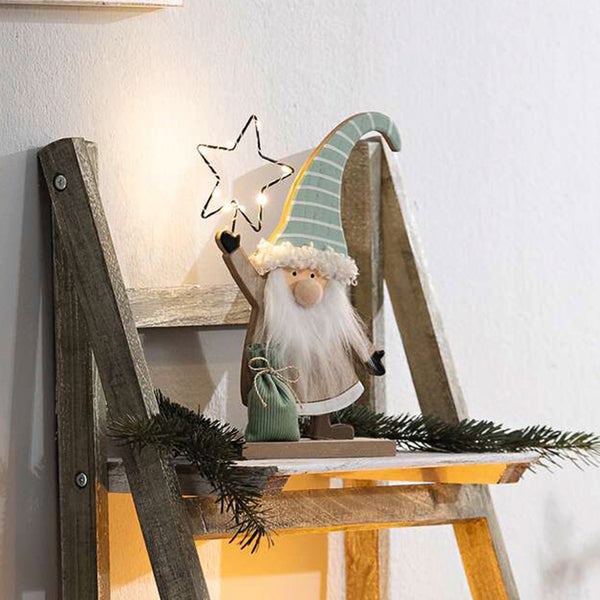 Dekorativer Weihnachtswichtel mit LED-Stern auf Holzleiter