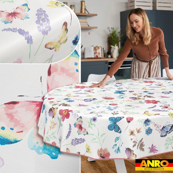 Rundes abwaschbares Wachstuch mit Schmetterlings- und Blumenmuster in einer hellen Küche. ANRO Logo.