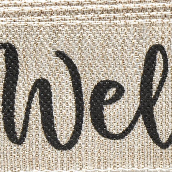 Detailaufnahme des Schriftzugs Willkommen auf einem Fußabtreter