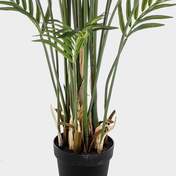 Künstlicher Dekozweig mit pfirsichfarbenen und grünen Blüten und Knospen aus Textilmaterial.