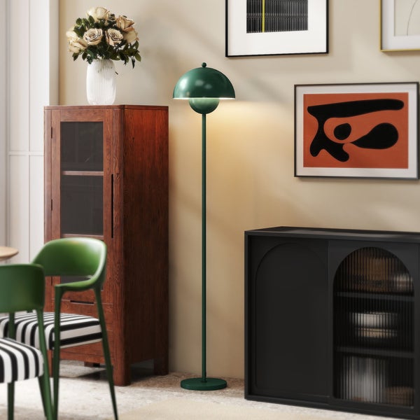 Innenraumansicht mit Stehlampe, Schrank und Dekorationsgegenständen.