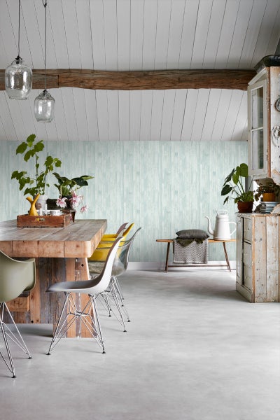 Heller Raum mit Esstisch, Stühlen, Bank und dekorativer Wandtapete in Holzoptik.