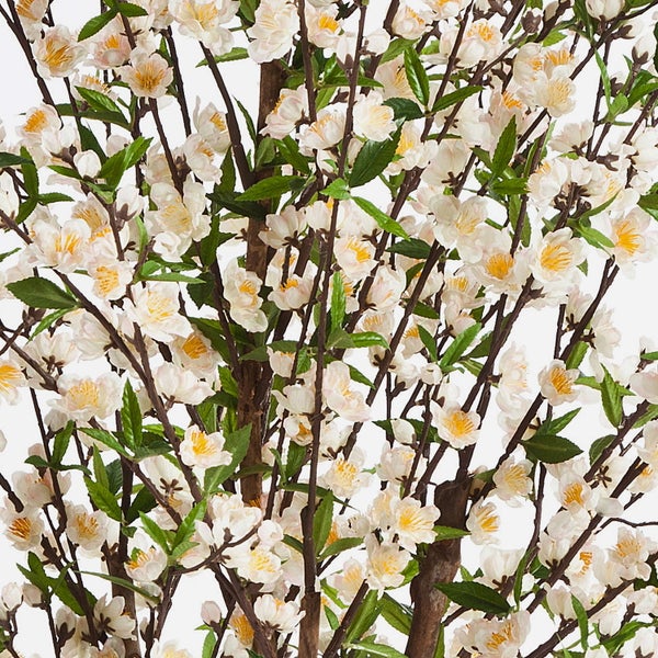Künstlicher Blütenbaum mit weißen Blüten, gelber Mitte und kleinen grünen Blättern an braunen Ästen.