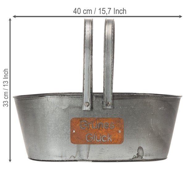 Ovaler Zinkkorb mit zwei Henkeln und dekorativem Schild Grünes Glück, Breite 40 Zentimeter und Höhe 33 Zentimeter.
