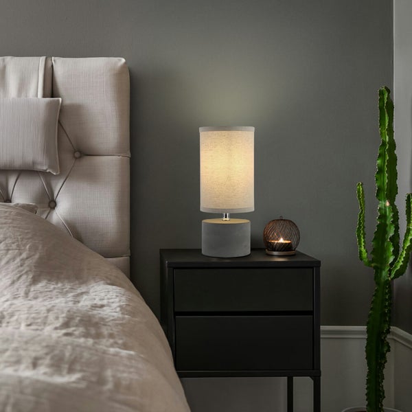 Schlafzimmer Szene mit Nachttischlampe, Kerze und Kaktus auf schwarzem Nachttisch