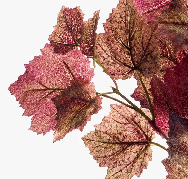 Künstlicher Zweig mit burgunderroten und bronzefarbenen Herbstblättern.