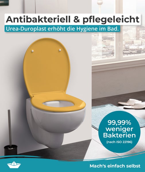Wand-WC mit gelbem WC-Sitz aus Urea-Duroplast, antibakteriell, reduziert Bakterien um 99,99 Prozent, montiert in einem hellen Badezimmer.