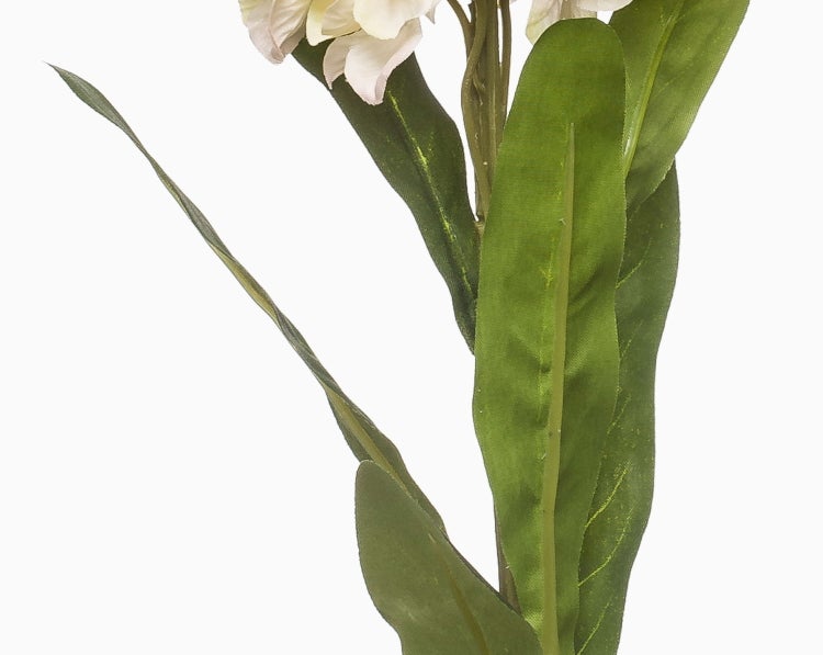 Detailansicht einer Kunstblume mit grünen Blättern und hellen Blütenblättern.