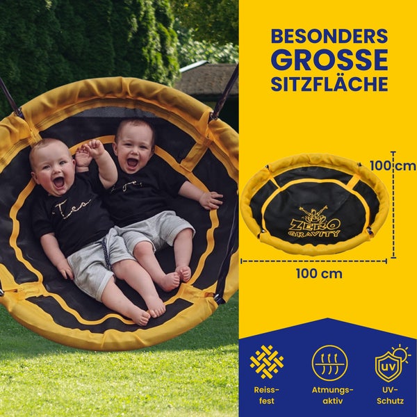 Zwei Kinder sitzen in einer runden, reißfesten Schaukel mit UV Schutz und atmungsaktiver Sitzfläche, Durchmesser 100 Zentimeter.