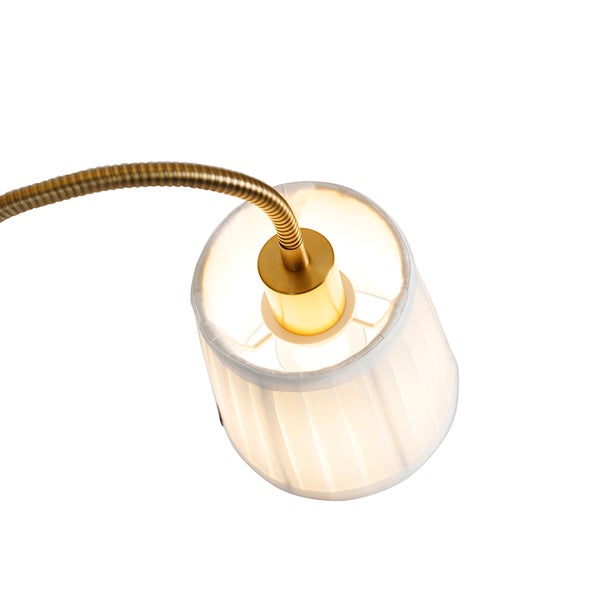 Nahaufnahme einer Schreibtischlampe mit Textilschirm und flexiblem Lampenarm