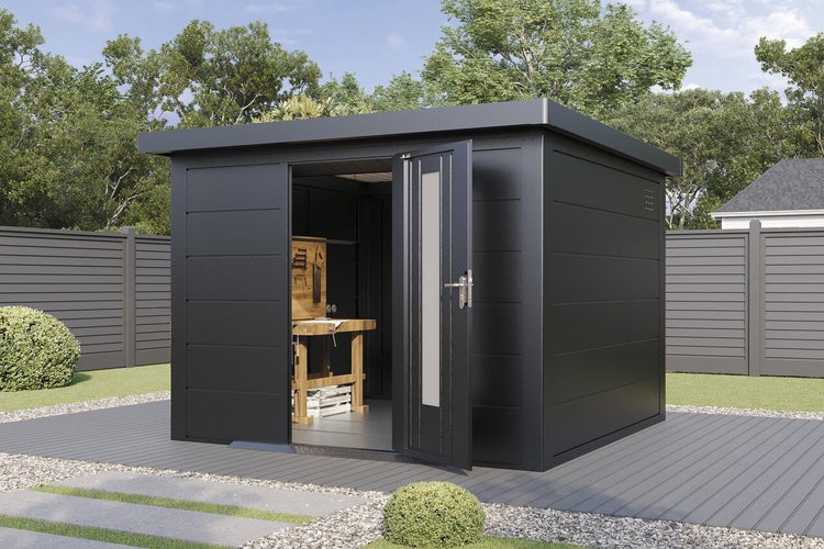 Modernes Gartenhaus aus Metall mit Flachdach und offener Eingangstür sowie einer Werkbank im Innenraum auf einer Terrasse im Garten.