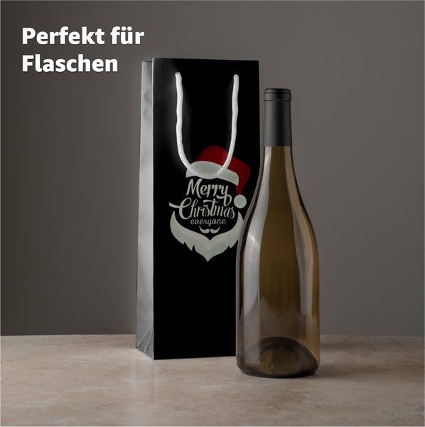 Geschenktasche mit Flaschenmotiv neben Weinflasche