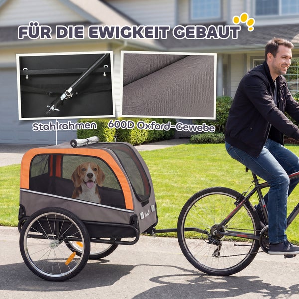 Fahrradanhänger für Hunde mit Stahlrahmen und Oxford-Gewebe, gezogen von einem Fahrradfahrer auf einer Straße.