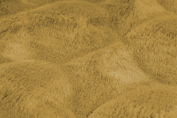 Strukturaufnahme einer weichen Wohndecke mit flauschiger Textur