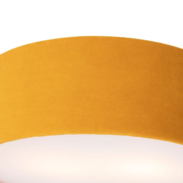 Detailaufnahme eines Lampenschirms mit gelber Samt-Oberfläche.