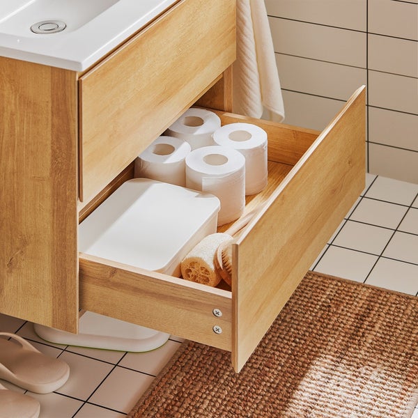 Offener Holzschrank im Badezimmer mit Toilettenpapier, Behälter und Bürste