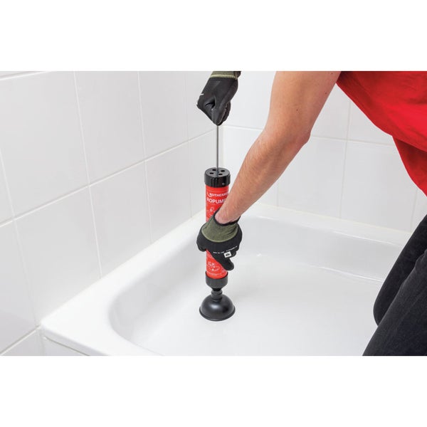 Eine Person benutzt eine Saugglocke in einer Badewanne, um eine Verstopfung zu lösen.