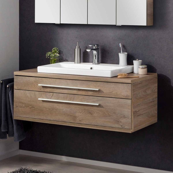 Waschtischunterschrank mit zwei Schubladen, Aufsatzwaschbecken und Armatur auf einer Badezimmerwand.