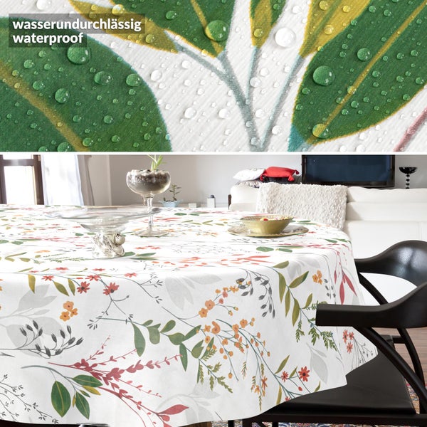 Wasserdichte runde Tischdecke mit Blumenmuster im Wohnzimmer, Detailansicht mit abperlenden Wassertropfen.