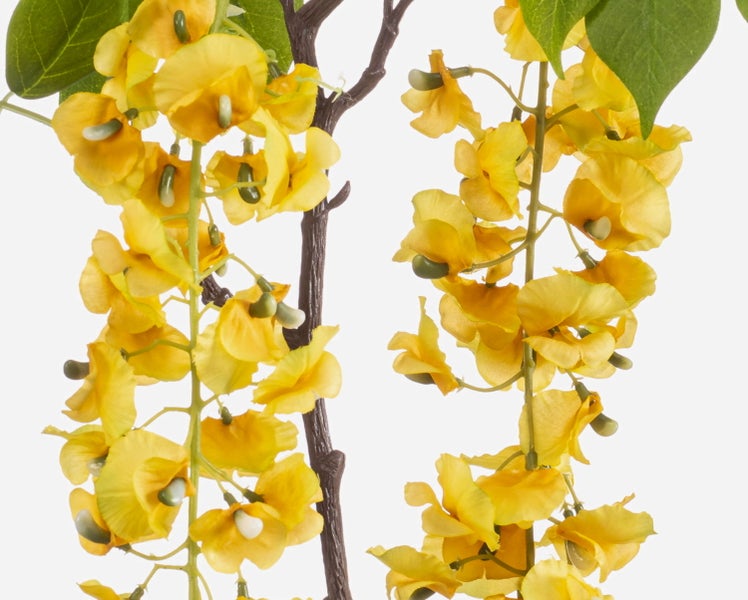 Künstliche gelbe Blüte mit grünen Blättern und Ranken aus Textil und Kunststoff.