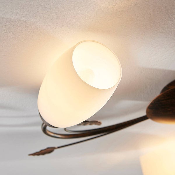 Deckenleuchte mit Glaslampenschirm und floralen Metallelementen