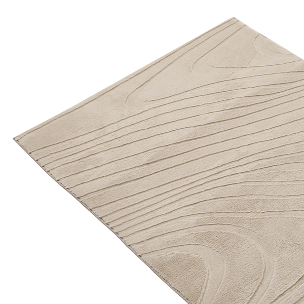 Detailaufnahme eines strukturierten Teppichs mit wellenförmigem Muster und weichem Flor.
