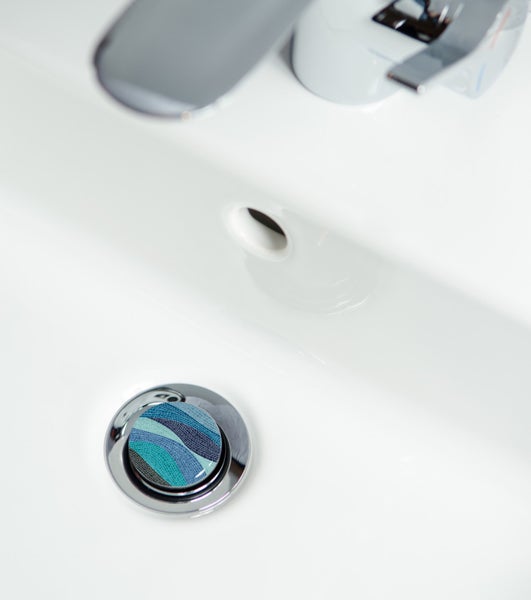 Waschbeckenstöpsel mit blauem Wellenmuster im Waschbecken