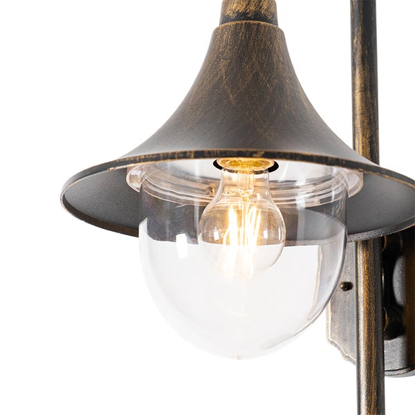 Außenwandleuchte im Vintage-Stil mit kegelförmigem Metallschirm in Antik-Optik, klarer Glaskuppel und sichtbarem Leuchtmittel.