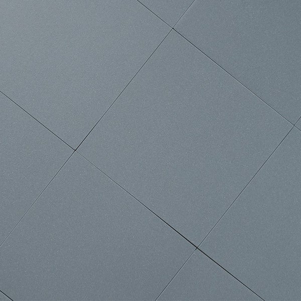 Quadratische Feinsteinzeugfliesen mit glatter Oberfläche für Boden oder Wand verlegt.