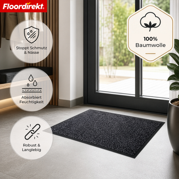 Floordirekt Logo. Schwarze Fußmatte aus 100 Prozent Baumwolle im Eingangsbereich. Sie stoppt Schmutz, absorbiert Feuchtigkeit und ist langlebig.