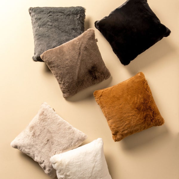 Mehrere quadratische Zierkissen mit Fellstruktur