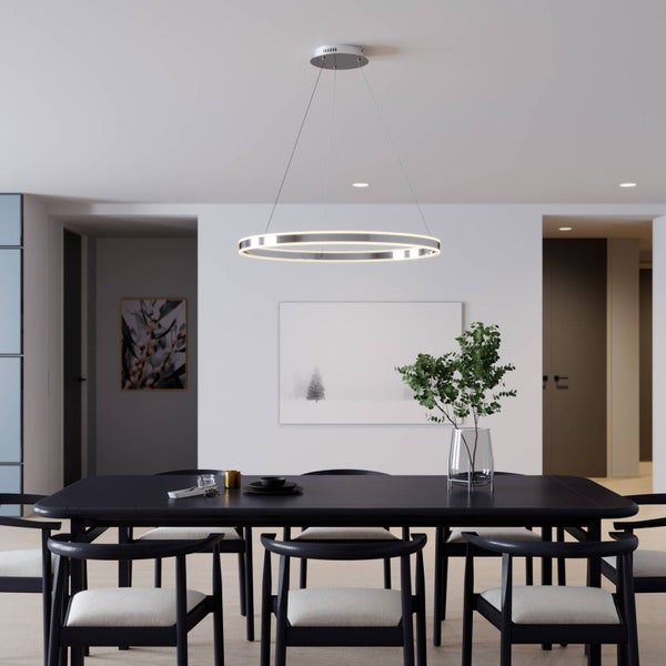 Moderne ringförmige LED-Pendelleuchte über einem dunklen Esstisch in einem hellen, minimalistischen Esszimmer.