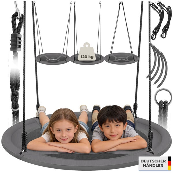 Zwei Kinder liegen auf einer runden Nestschaukel mit Seilen und Montagematerial sowie Gewichtsangabe von 120 Kilogramm.