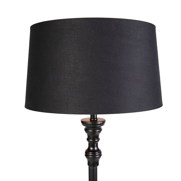 Lampe mit schwarzem Stoffschirm und gedrechseltem Standfuß.