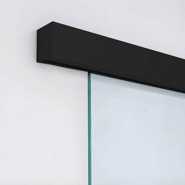 Detailaufnahme einer Glasschiebetür mit schwarzer Schiene an einer Wand.