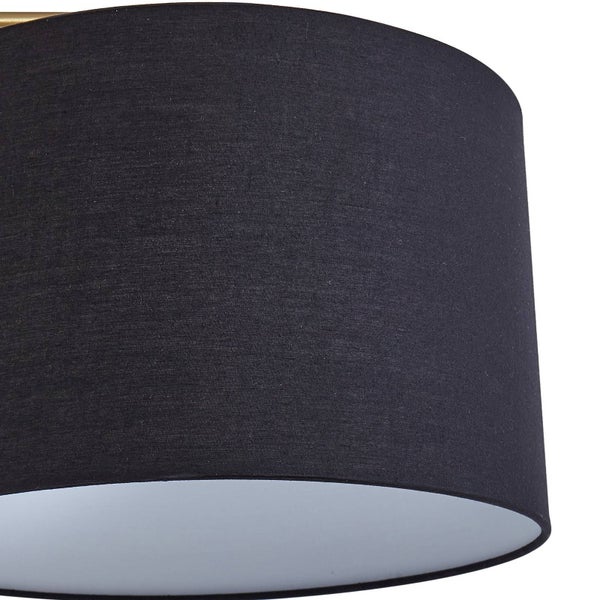 Schwarzer zylindrischer Lampenschirm aus Stoff mit weißer Innenseite.
