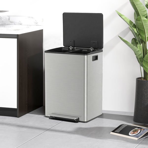 Treteimer aus Edelstahl zur Mülltrennung mit zwei Fächern, geöffneter Deckel, in einer modernen Küche neben einem Schrank und einer Pflanze.