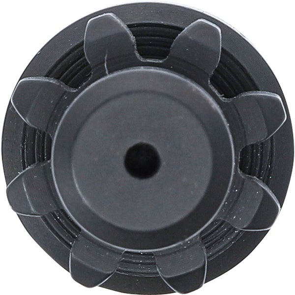 Schwarzes, rundes Bauteil mit zentraler Öffnung und radial angeordneten Aussparungen