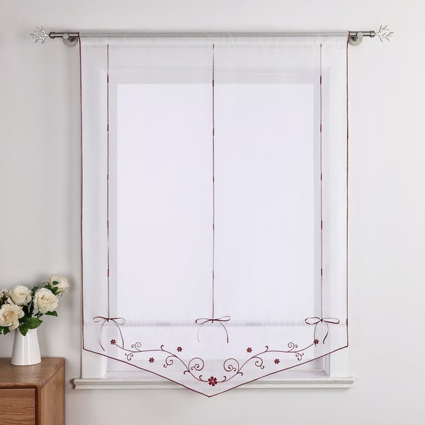 Gardine mit Blumenmuster am Fenster