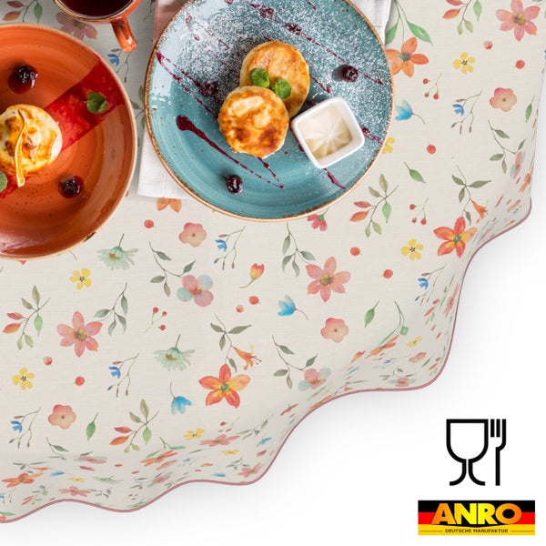 Abwaschbare Tischdecke mit buntem Blumenmuster, lebensmittelecht, ANRO DEUTSCHE MANUFAKTUR Logo.