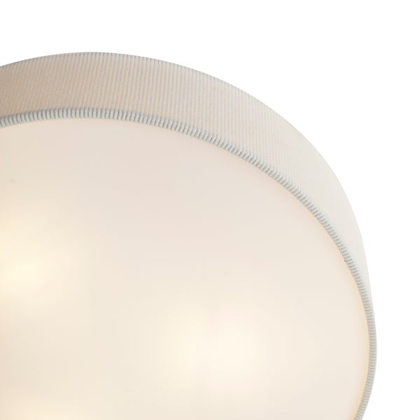 Detailansicht einer runden Deckenleuchte mit geriffeltem Textilrand und einem glatten Diffusor.