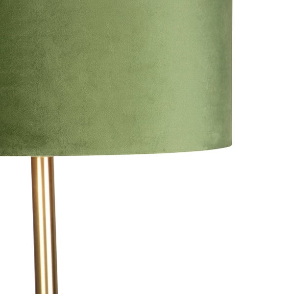 Detailansicht einer Lampe mit zylindrischem Schirm aus grünem Samt und einem Ständer aus goldfarbenem Metall.