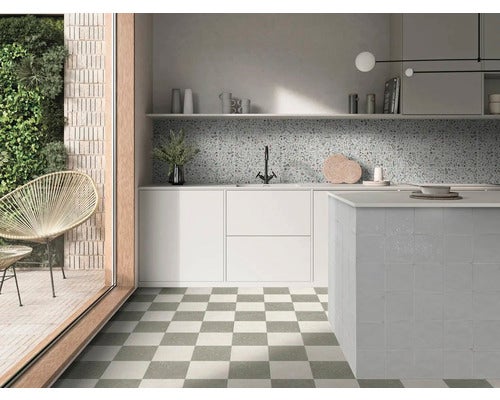 Moderne helle Küche mit Kücheninsel, Terrazzo-Fliesenspiegel und Bodenfliesen im Schachbrettmuster.