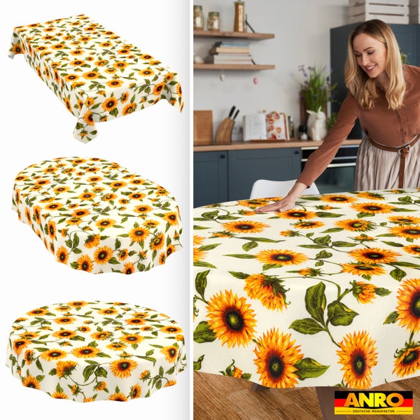 Tischdecke mit Sonnenblumenmuster in rechteckig, oval und rund. Eine Frau deckt in einer hellen Küche einen Tisch. ANRO Logo.