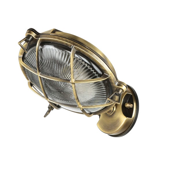 Goldfarbene Wandleuchte mit Schutzgitter und geriffeltem Glas