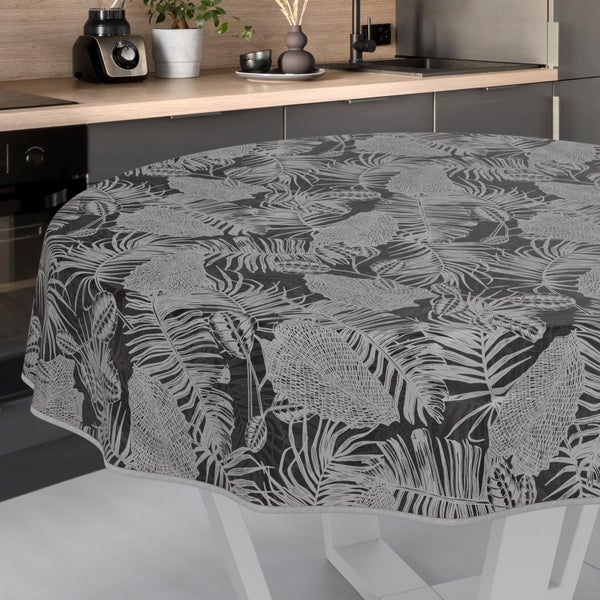 Runde Tischdecke mit tropischem Blattmuster, abgebildet auf einem Tisch in einer modernen Küche.