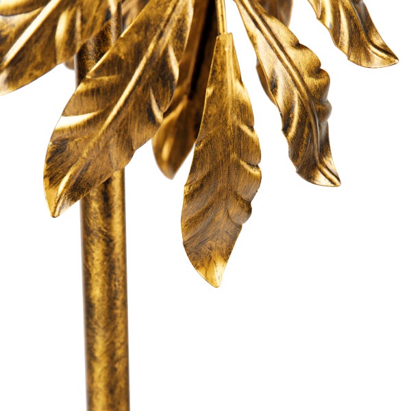 Nahaufnahme einer goldenen Dekopalme mit filigranen Blättern.