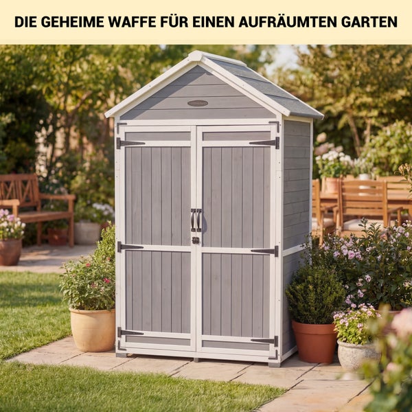Gartenschrank aus grauem Holz mit weißen Akzenten und Satteldach, auf einer Terrasse zwischen Pflanzen und Gartenmöbeln.