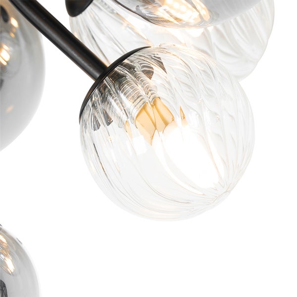 Nahaufnahme einer Leuchte mit klaren Glaskugeln an einem schwarzen Gestell